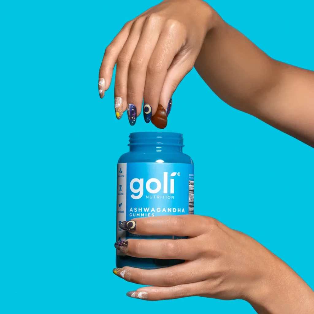 Hand holding Goli Ashwagandha Gummies bottle